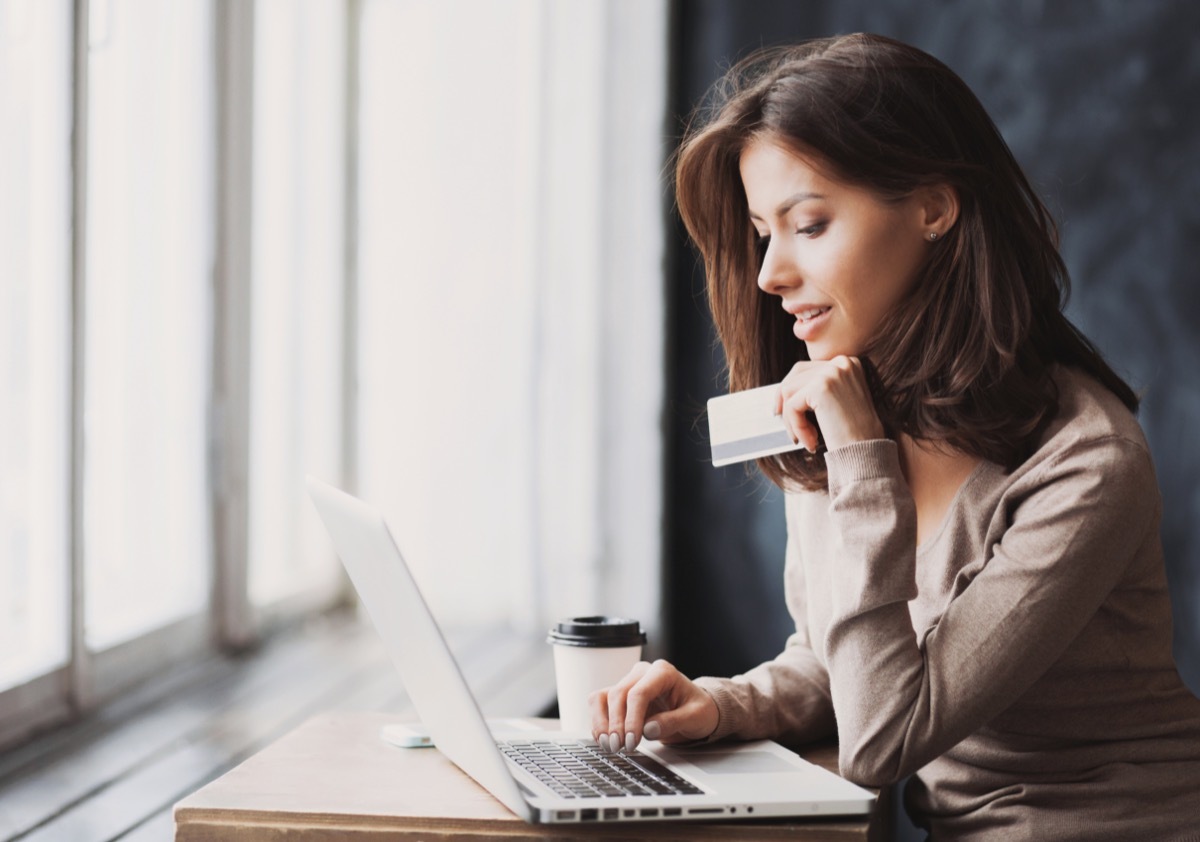 young woman shopping online with credit card