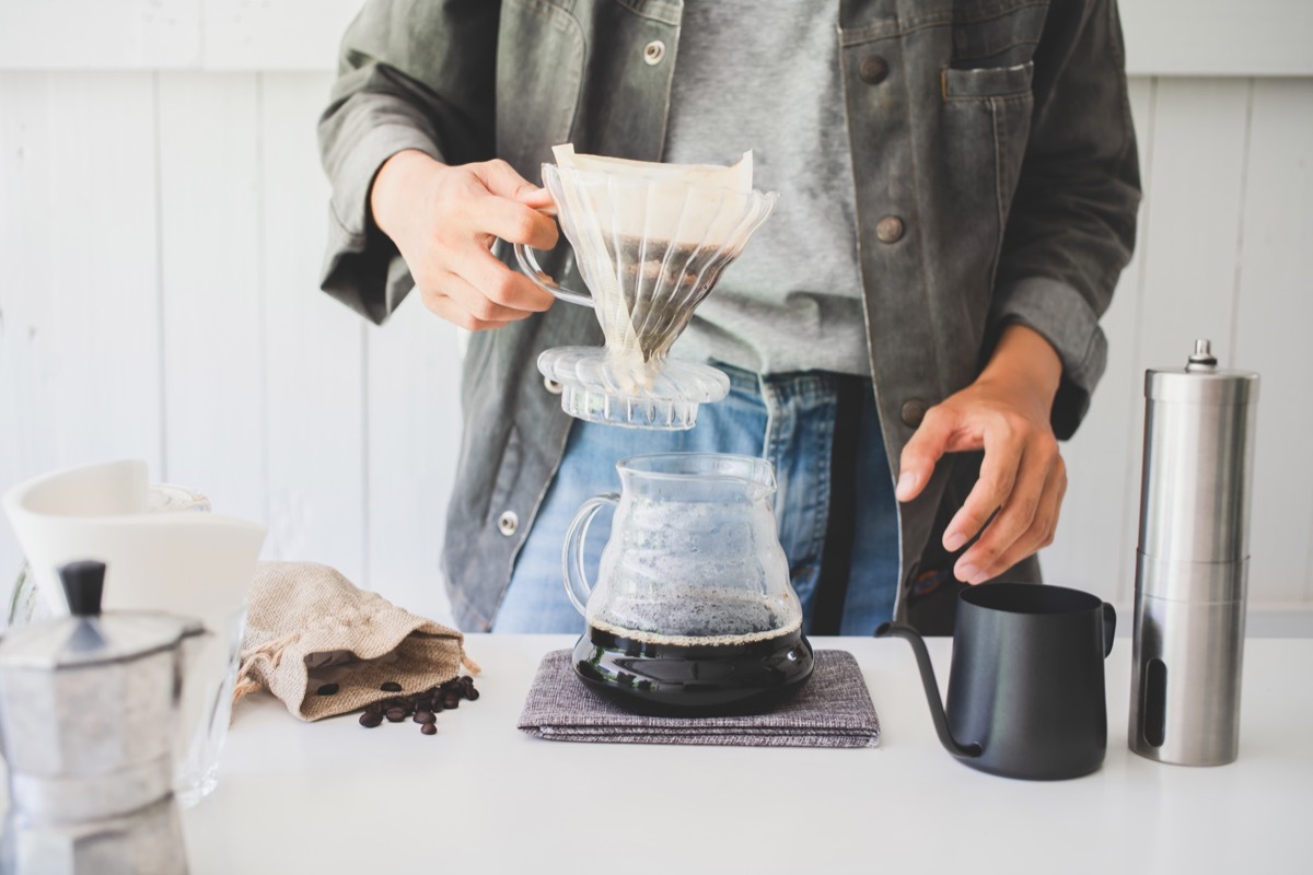 Woman making coffee at home